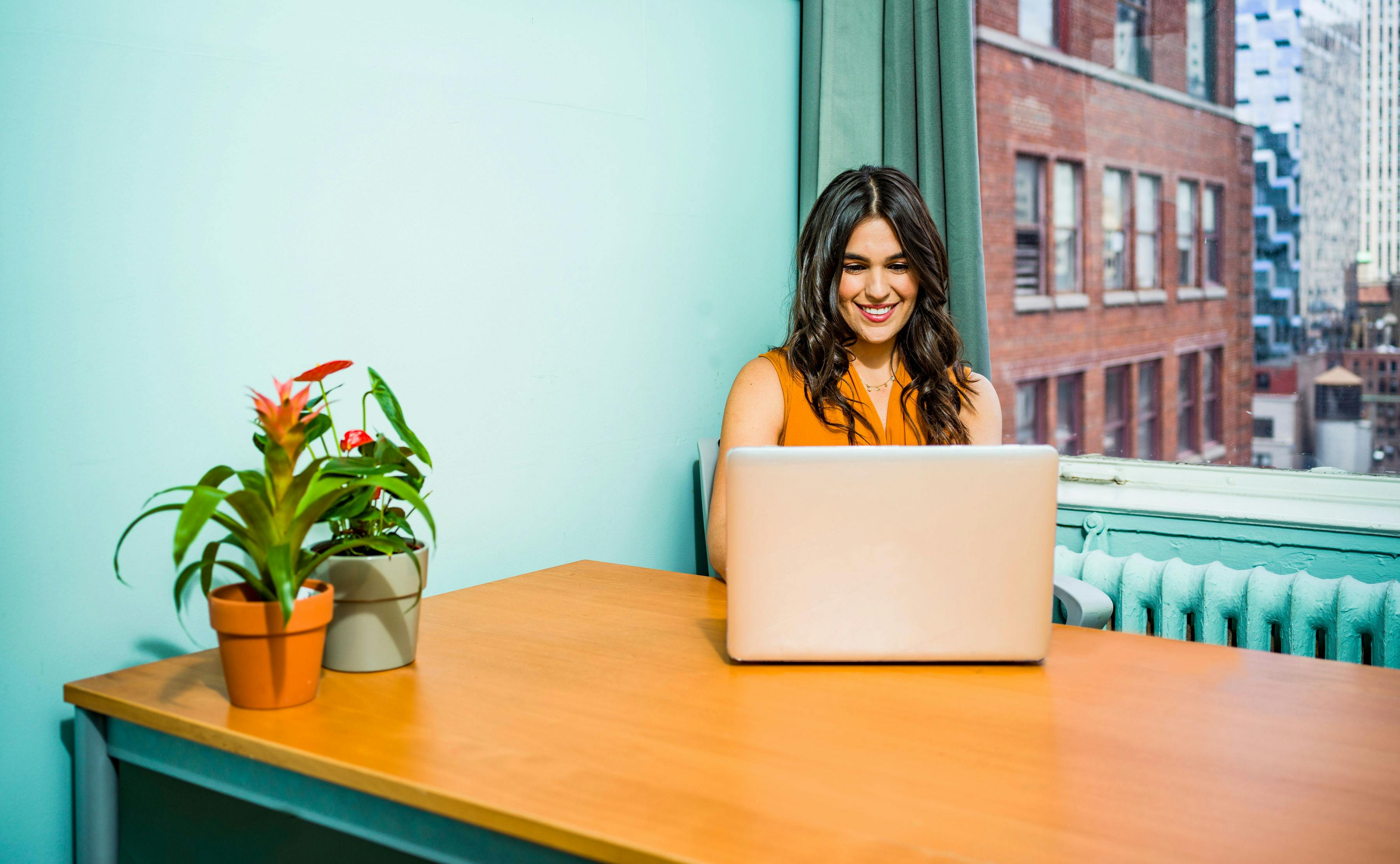 woman using a laptop,smiling